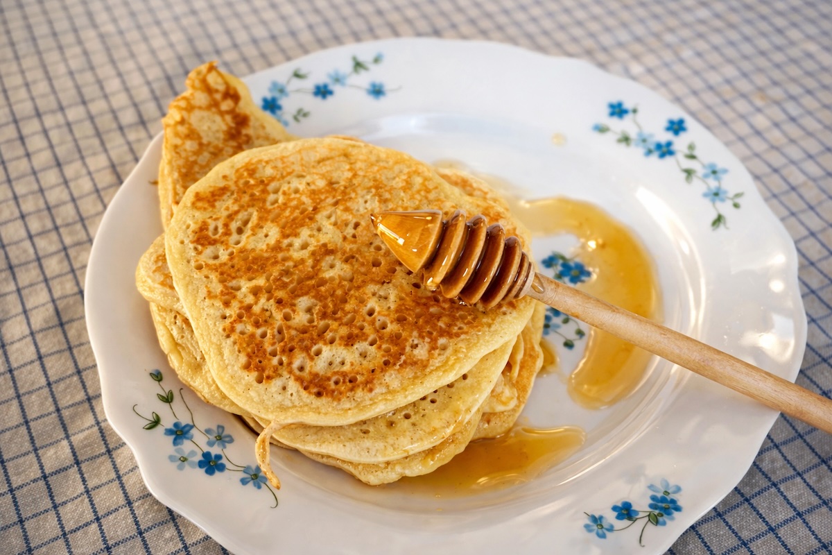 Pile de pancakes épais dorés nappés de sirop d'érable